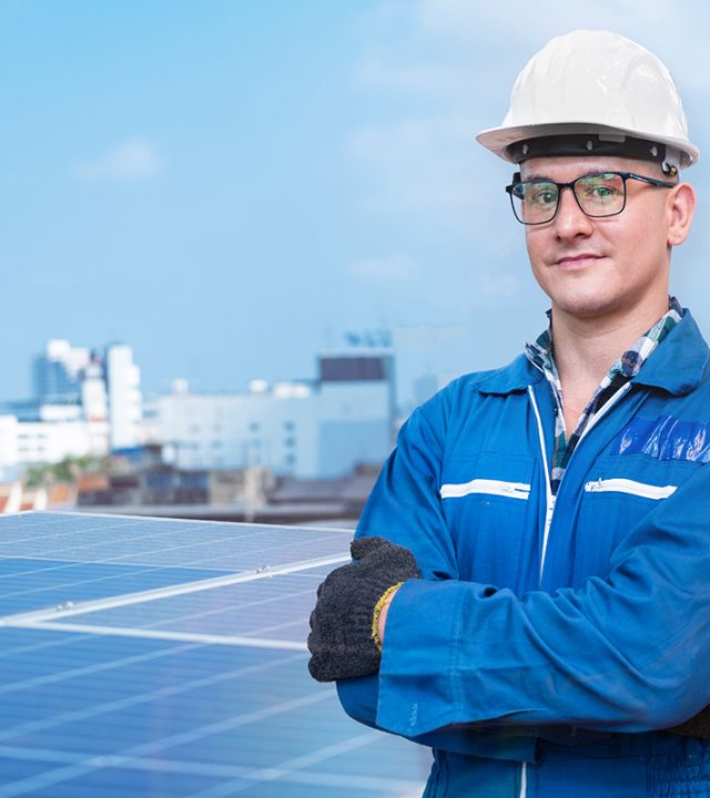 Portrait of engineer man worker is standing with confident at co Portrait of engineer man worker is standing with confident at construction of solar cell panel or photovoltaic. Industrial Renewable energy. factory worker working on tower roof and skyscrapercity.